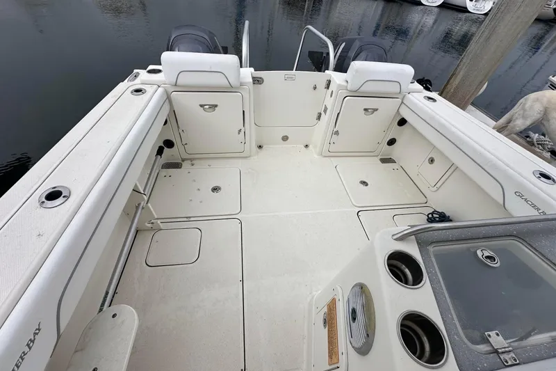 Slide: The Image of 2013 Glacier Bay 2680 Coastal Runner boat deck with storage compartments and seating. - 4