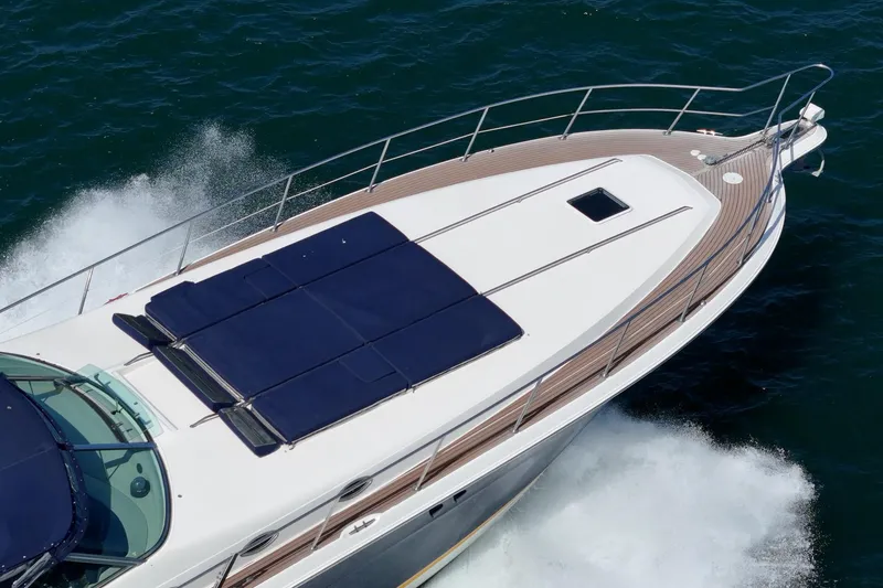 Slide: The Image of 1999 Sea Ray 500 Sundancer yacht cruising on open water, top deck view. - 3