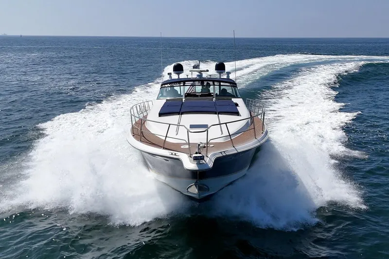Slide: The Image of 1999 Sea Ray 500 Sundancer yacht cruising on open water, creating a dynamic wake. - 6