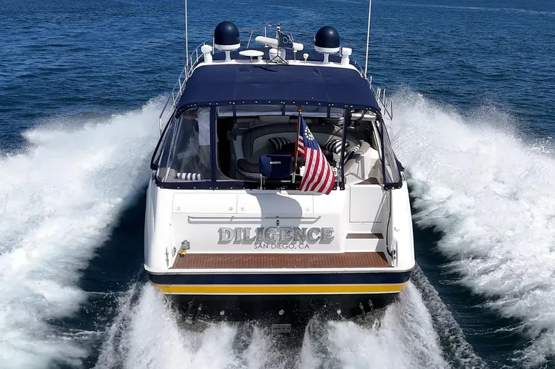 Slide: The Image of 1999 Sea Ray 500 Sundancer yacht cruising with American flag, named "Diligence," in San Diego waters. - 7