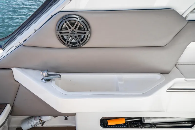Slide: The Image of Interior of 1999 Sea Ray 500 Sundancer with speaker, sink, and storage compartment. - 9