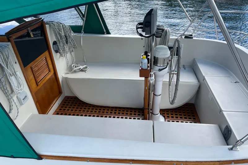 Slide: The Image of 1981 Nonsuch 30 Classic sailboat cockpit with green canopy and wooden accents. - 3