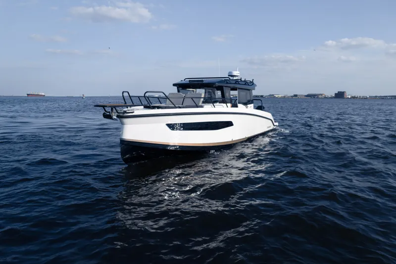 Slide: The Image of A modern motorboat cruises on calm water under a blue sky. - 2