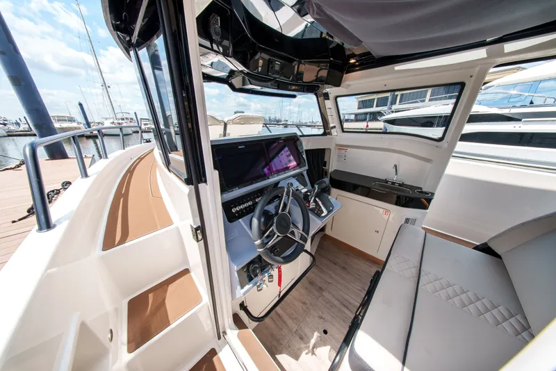 Slide: The Image of The interior of a modern boat with a steering wheel and navigation system. - 11