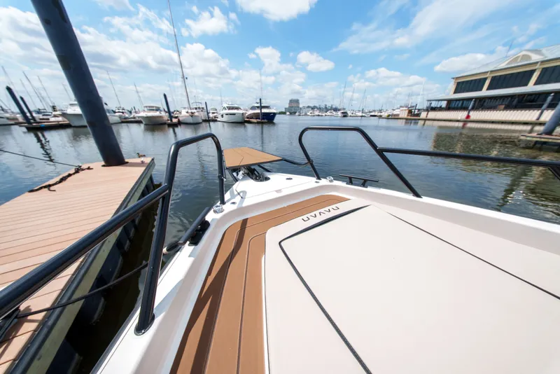Slide: The Image of A modern boat is docked in a marina, surrounded by other boats and a pier. - 12
