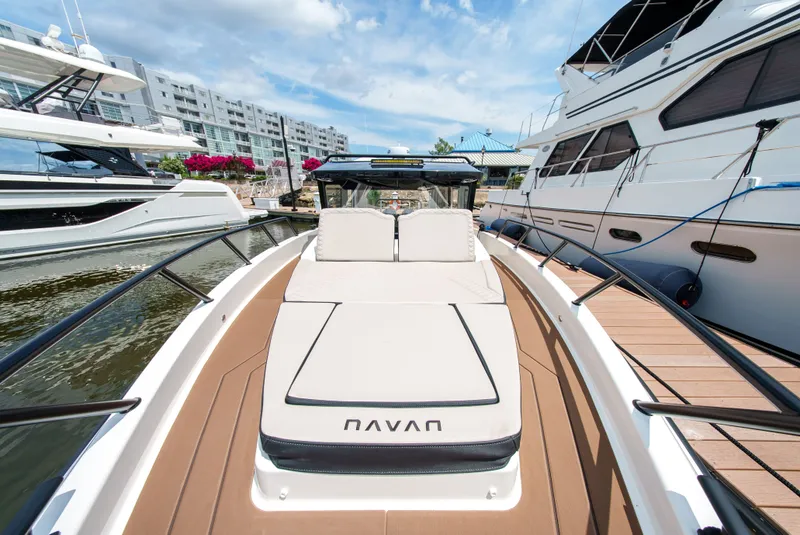 Slide: The Image of A modern boat with a sunbathing area in a marina, surrounded by other yachts. - 13