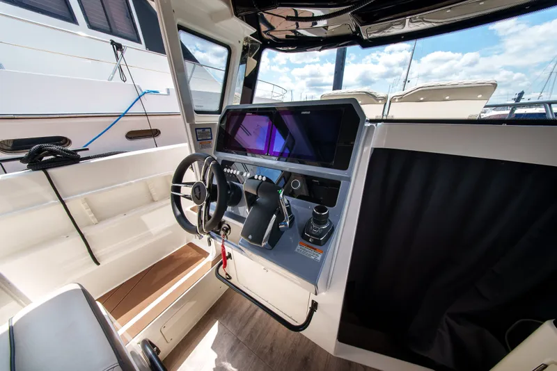 Slide: The Image of The cockpit of a modern boat with a steering wheel and instrument panel. - 18