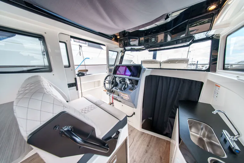 Slide: The Image of Interior view of a modern boat with steering wheel, seat, and sink. - 19