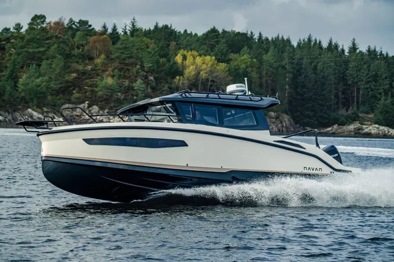 The Image of Navan C-30 from 2026 cruising on a lake, surrounded by wooded hills. - 0