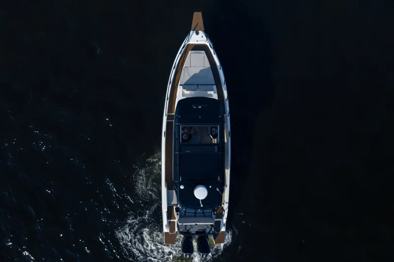 Slide: The Image of A modern boat with sleek design cruising on dark water. - 3