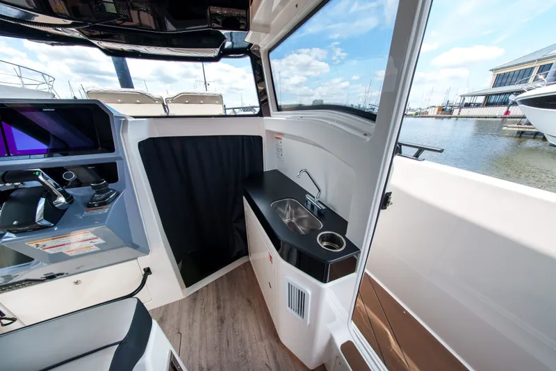 Slide: The Image of Interior view of a modern boat with a helm console and small sink. - 22