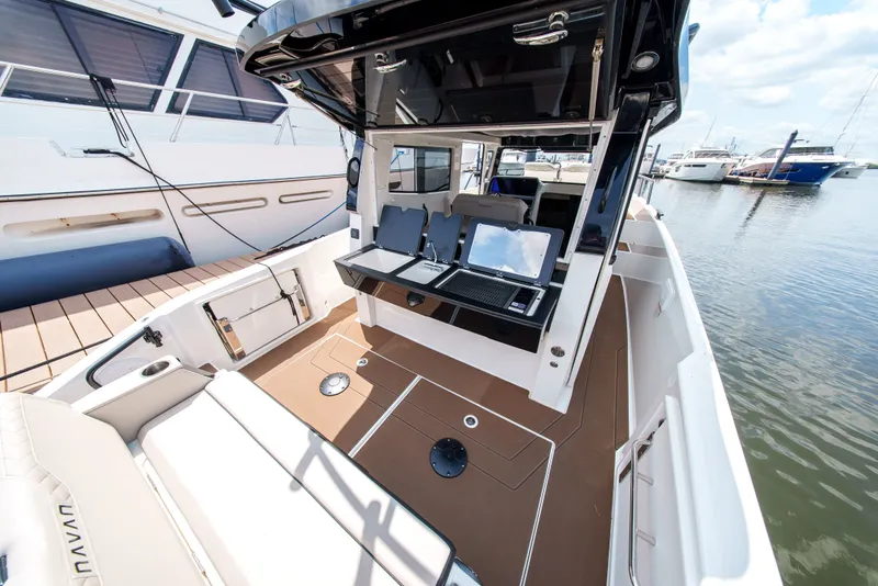 Slide: The Image of A modern boat with an open deck and comfortable seating in a marina. - 8