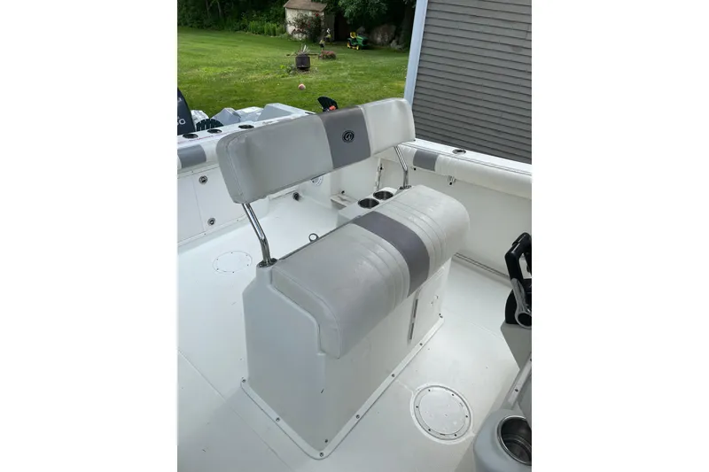 Slide: The Image of 2006 Sailfish 2660 CC boat interior with cushioned seating and cup holders. - 10