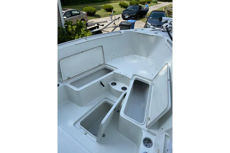 Slide: The Image of 2006 Sailfish 2660 CC boat interior with open storage compartments. - 13