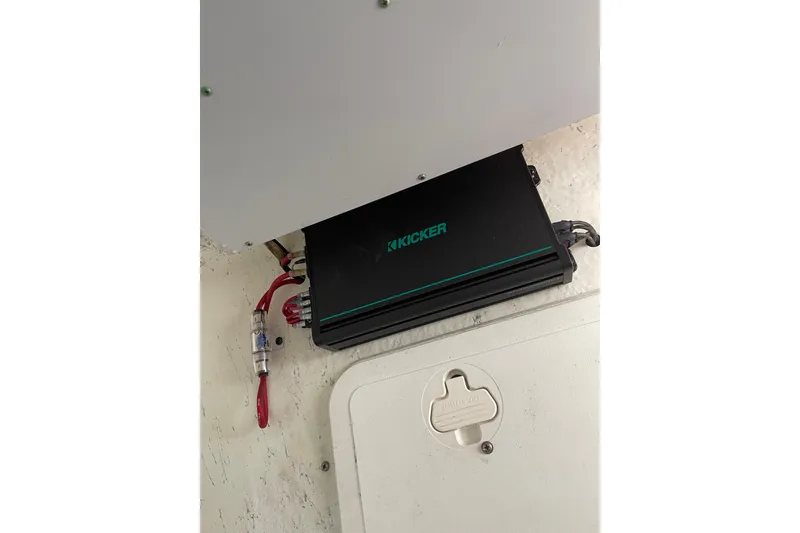 Slide: The Image of Kicker amplifier installed on a 2006 Sailfish 2660 CC boat interior. - 14