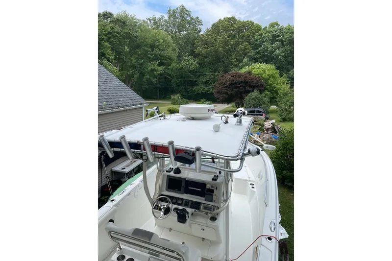 Slide: The Image of 2006 Sailfish 2660 CC boat with electronics, surrounded by lush greenery. - 6