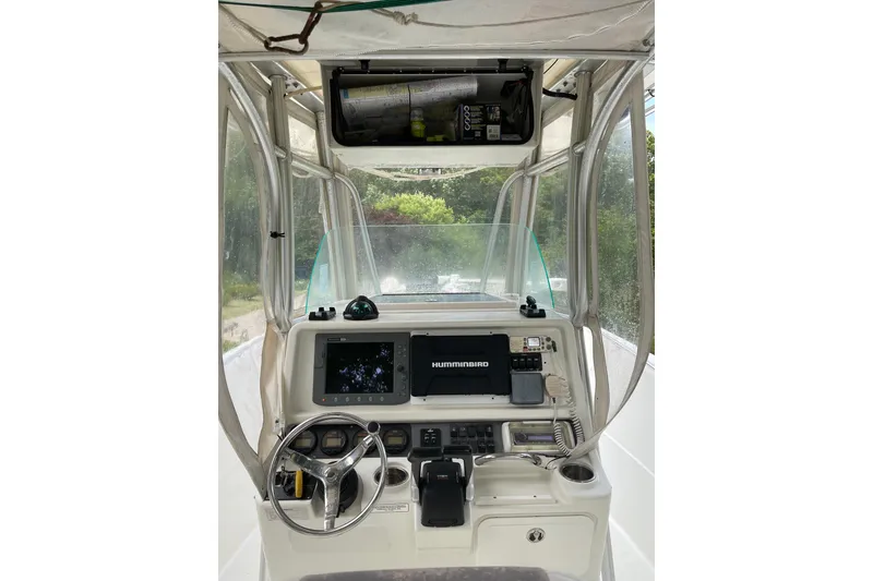 Slide: The Image of 2006 Sailfish 2660 CC boat cockpit with steering wheel and navigation equipment. - 8