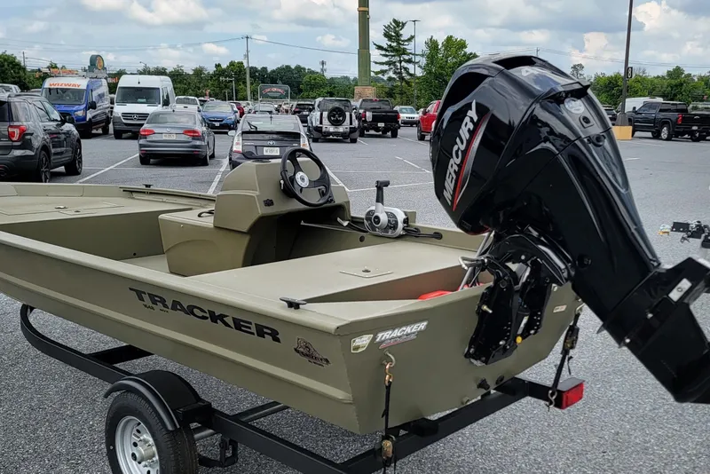 Slide: The Image of 2026 Tracker Grizzly 1648 SC boat with Mercury engine in parking lot. - 3