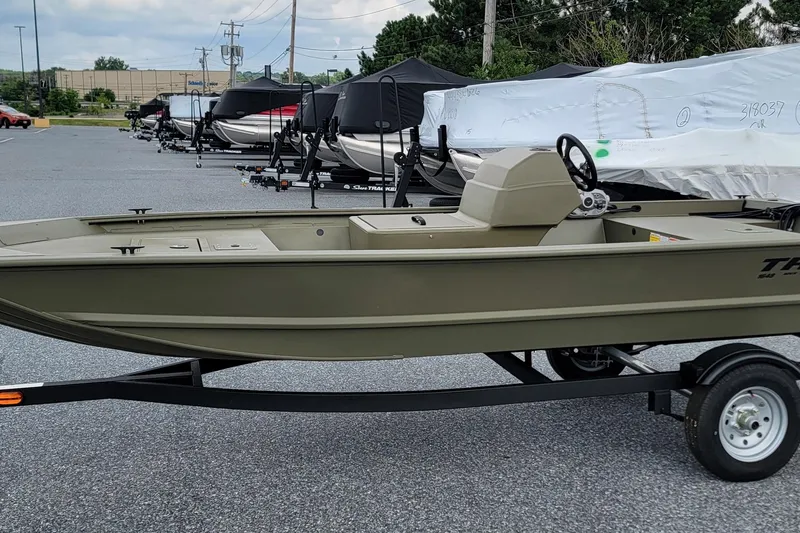 Slide: The Image of 2026 Tracker Grizzly 1648 SC boat on trailer in parking lot. - 4