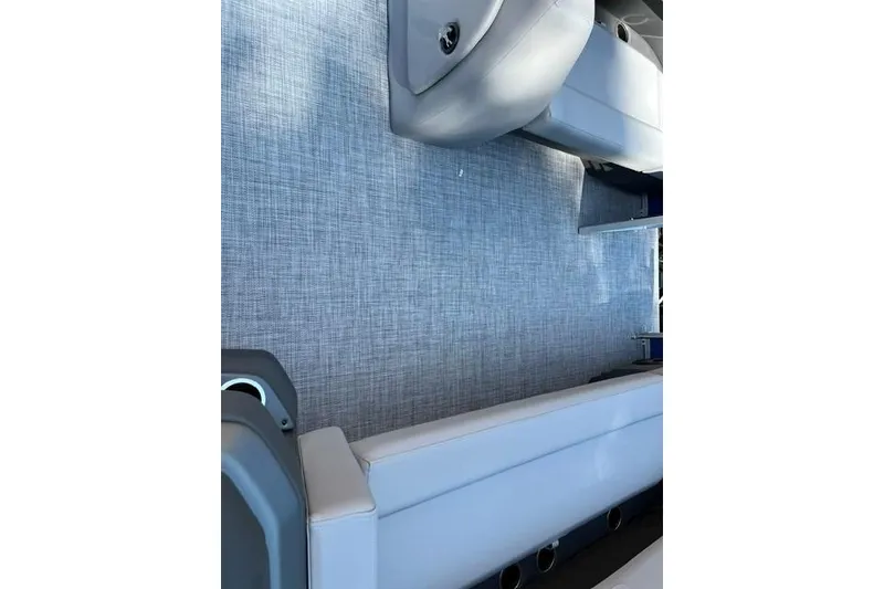 Slide: The Image of Interior view of 2026 Sun Tracker Party Barge 18 DLX with gray seating and flooring. - 10