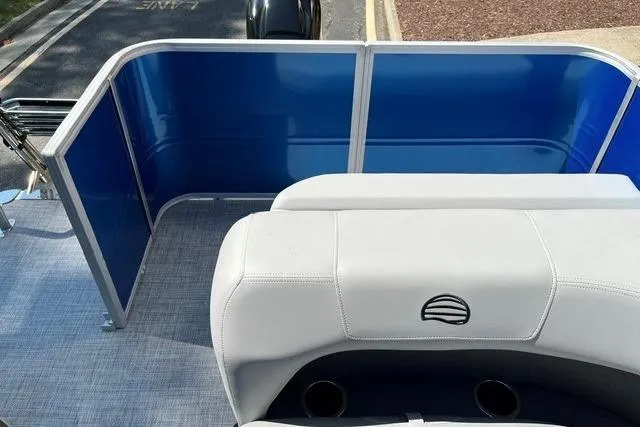 Slide: The Image of 2026 Sun Tracker Party Barge 18 DLX interior with blue panels and white seating. - 7