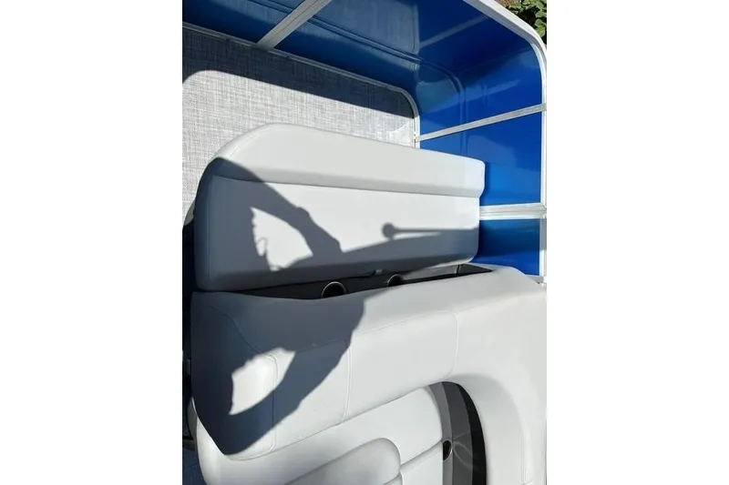 Slide: The Image of 2026 Sun Tracker Party Barge 18 DLX interior with blue and gray seating. - 8