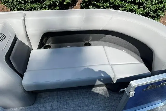 Slide: The Image of 2026 Sun Tracker Party Barge 18 DLX interior seating with gray upholstery and cup holders. - 11