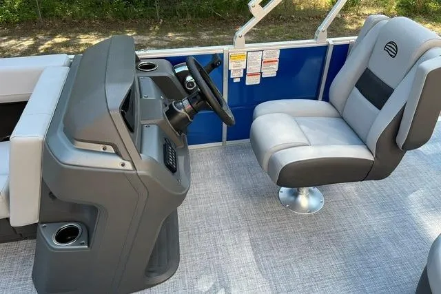 Slide: The Image of 2026 Sun Tracker Party Barge 18 DLX interior with steering console and seating. - 6