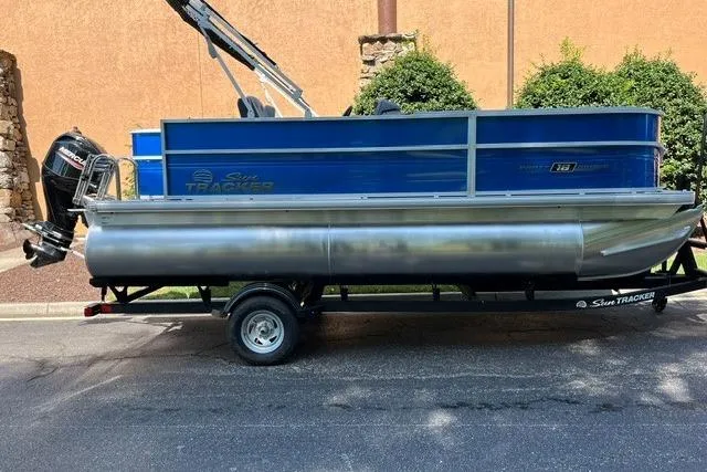 The Image of 2026 Sun Tracker Party Barge 18 DLX pontoon boat on trailer, side view. - 0