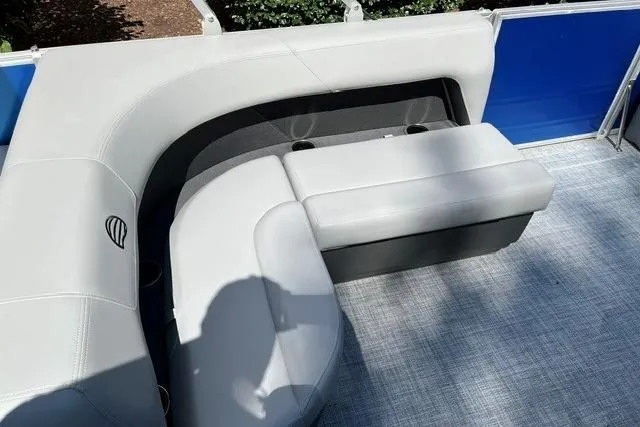 Slide: The Image of 2026 Sun Tracker Party Barge 18 DLX pontoon boat seating area with gray upholstery. - 9
