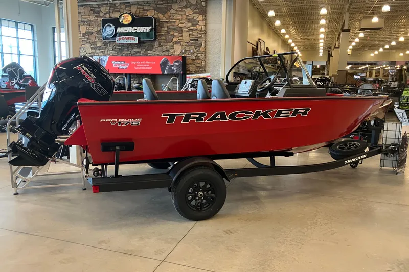 The Image of 2026 Tracker Pro Guide V-175 WT boat displayed indoors, red exterior, Mercury engine. - 0
