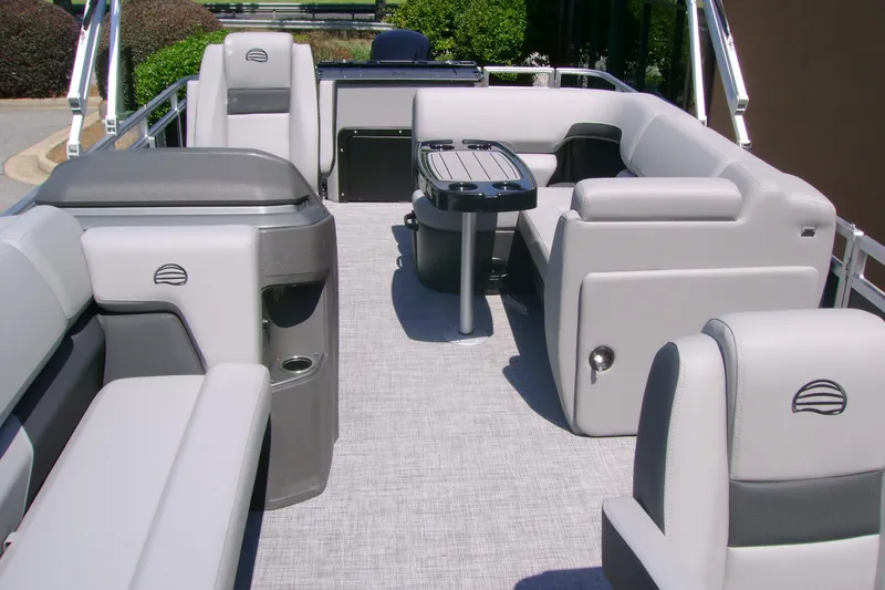 Slide: The Image of 2026 Sun Tracker SportFish 20 DLX pontoon boat interior with plush seating and table. - 5