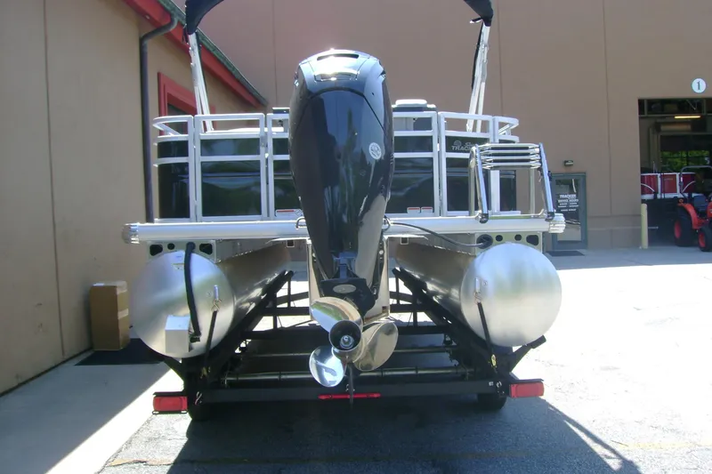 Slide: The Image of 2026 Sun Tracker SportFish 20 DLX pontoon boat with powerful outboard motor, parked outdoors. - 4