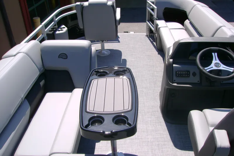 Slide: The Image of Interior of 2026 Sun Tracker SportFish 20 DLX pontoon boat with seating and steering console. - 6