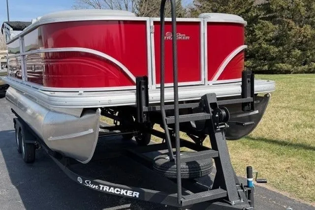 The Image of 2026 Sun Tracker Party Barge 20 DLX pontoon boat on trailer, red exterior. - 0