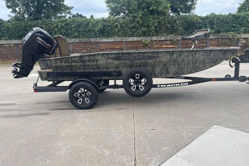 The Image of 2026 Tracker Grizzly 1650 T Prairie Wings Edition boat on trailer, outdoors. - 0