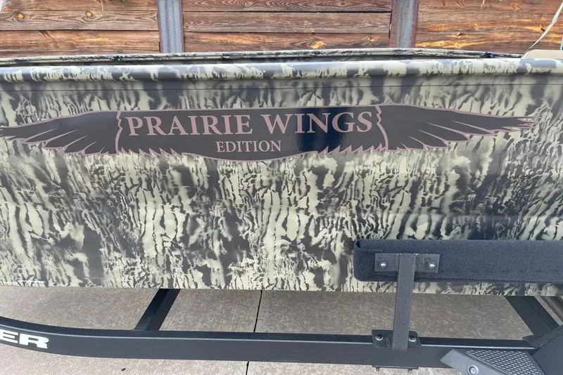 Slide: The Image of 2026 Tracker Grizzly 1650 T Prairie Wings Edition with camouflage design and logo. - 4