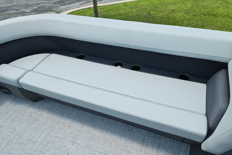 Slide: The Image of 2026 Sun Tracker Party Barge 18 DLX seating area with cup holders, gray upholstery. - 16