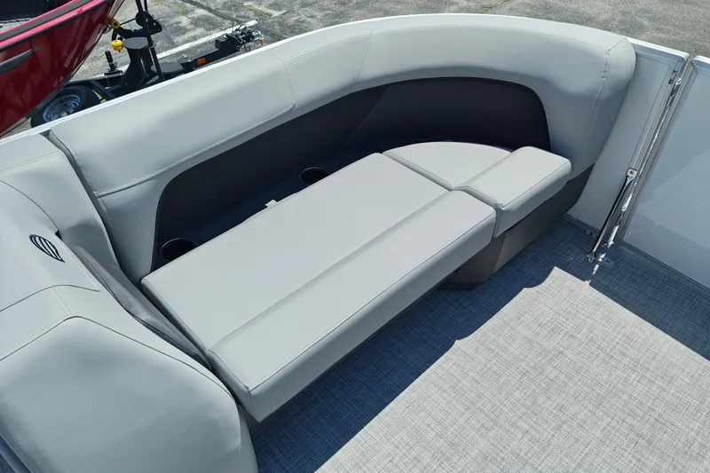 Slide: The Image of 2026 Sun Tracker Party Barge 18 DLX interior with gray seating and cup holders. - 18