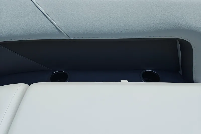 Slide: The Image of 2026 Sun Tracker Party Barge 18 DLX interior with cup holders and cushioned seating. - 11