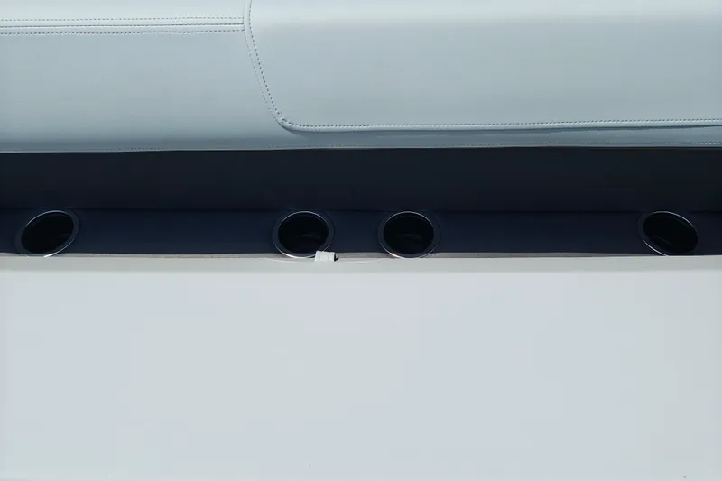 Slide: The Image of 2026 Sun Tracker Party Barge 18 DLX interior with cup holders and seating detail. - 17