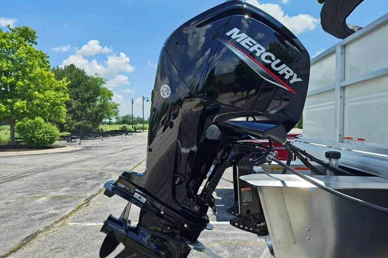 Slide: The Image of Mercury outboard motor on 2026 Sun Tracker Party Barge 18 DLX, parked outdoors. - 21