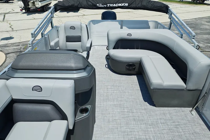 Slide: The Image of 2026 Sun Tracker Party Barge 18 DLX interior with gray seating and spacious layout. - 4