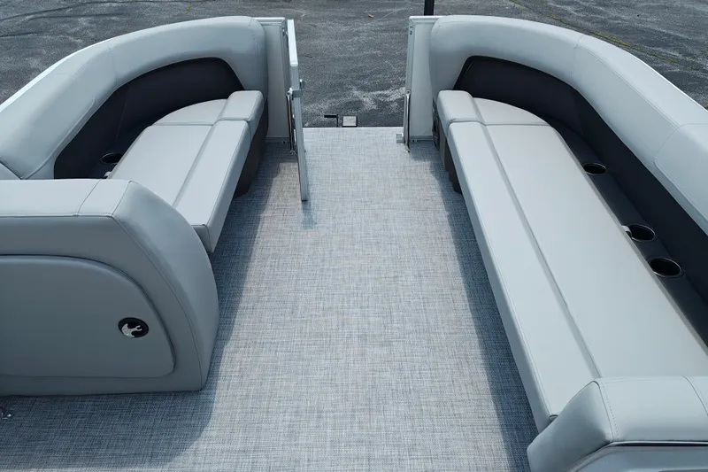 Slide: The Image of 2026 Sun Tracker Party Barge 18 DLX interior with gray seating and cup holders. - 15
