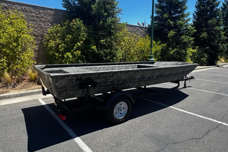 Slide: The Image of 2026 Tracker Grizzly 1860 Utility boat on trailer in parking lot. - 4