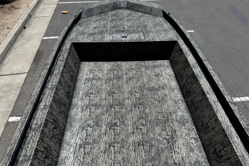 Slide: The Image of 2026 Tracker Grizzly 1860 Utility boat with camouflage pattern, parked on asphalt. - 7