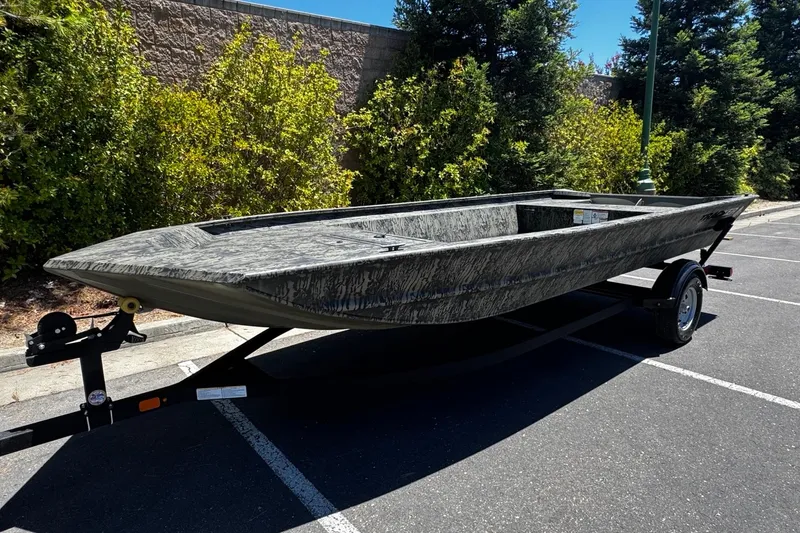 Slide: The Image of 2026 Tracker Grizzly 1860 Utility boat on trailer in parking lot. - 5