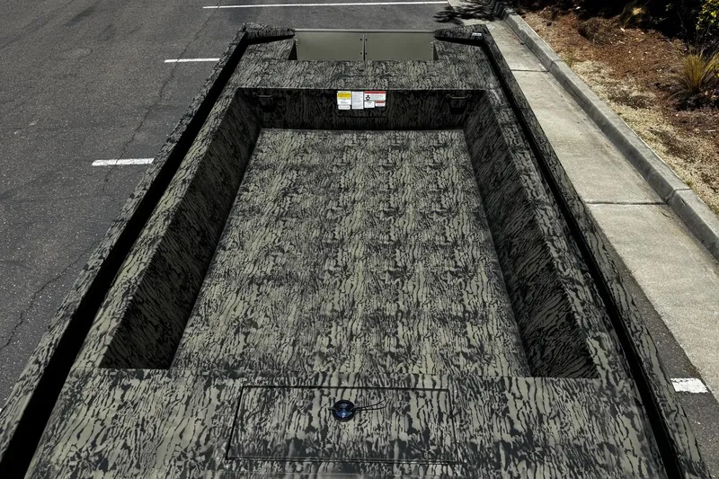 Slide: The Image of 2026 Tracker Grizzly 1860 Utility boat with camouflage pattern parked on asphalt. - 8