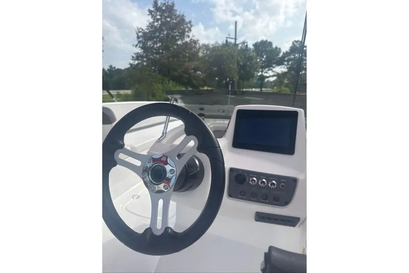 Slide: The Image of 2026 Tahoe T18 boat dashboard with steering wheel and control panel. - 5