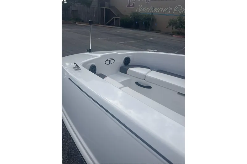 Slide: The Image of 2026 Tahoe T18 boat interior with white seating and sleek design in a parking area. - 6
